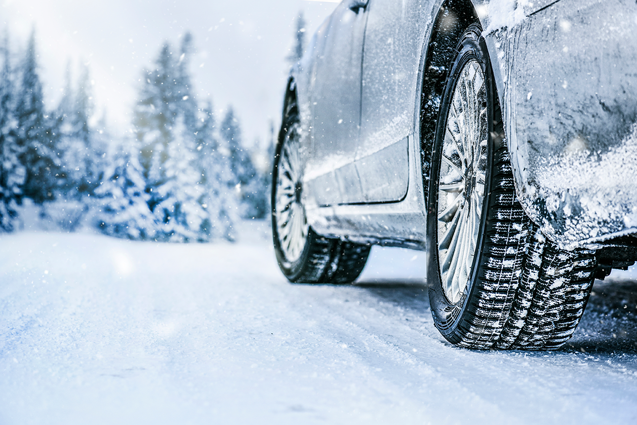 Close of car tire on icy road