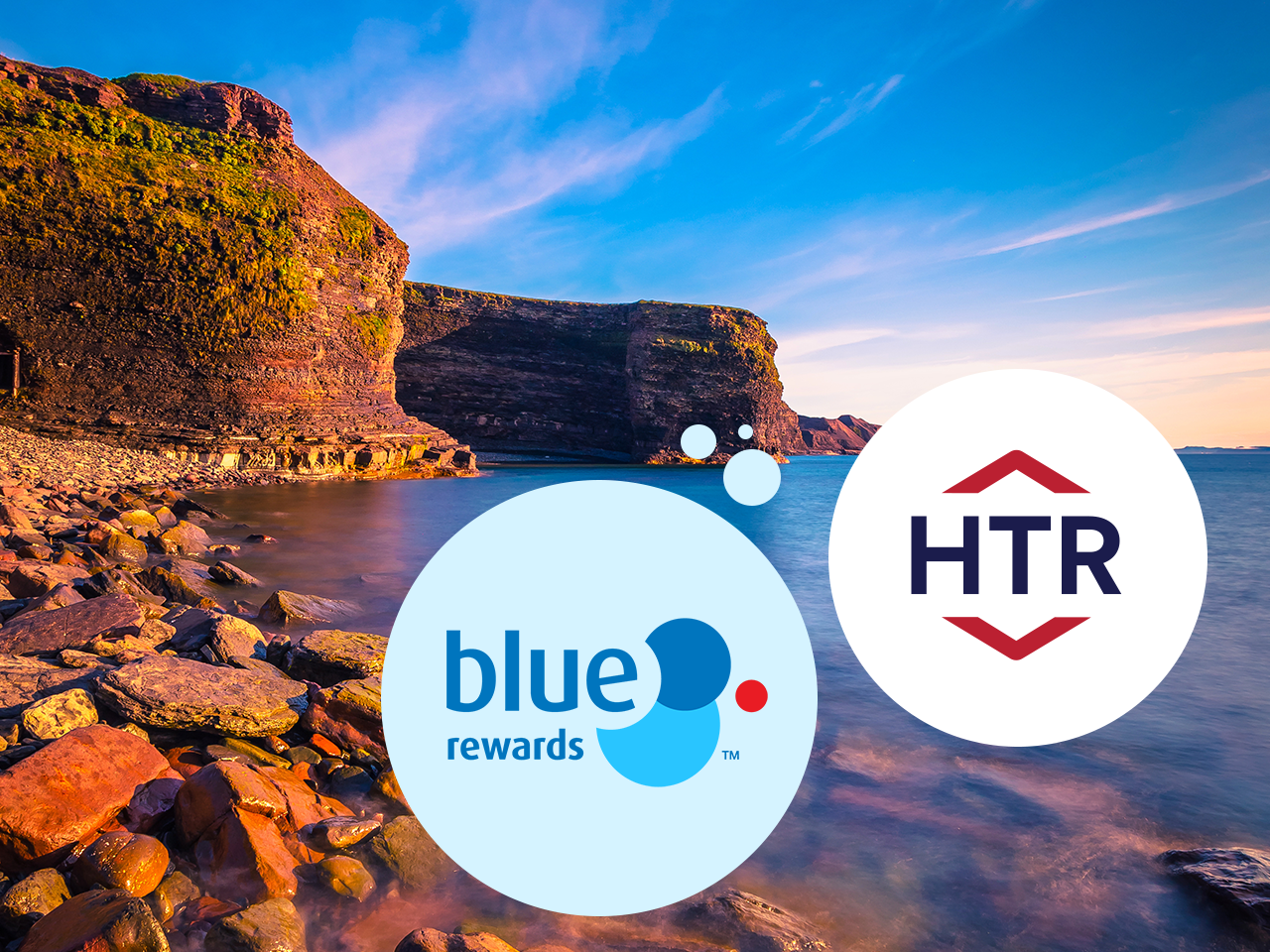 A scenic view with Mountains in the background and rocks along the shore. Blue Rewards bubble in the foreground and Hometown rewards bubble on the right side of it