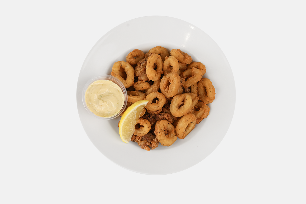 A plate of crispy fried calamari with tartar sauce