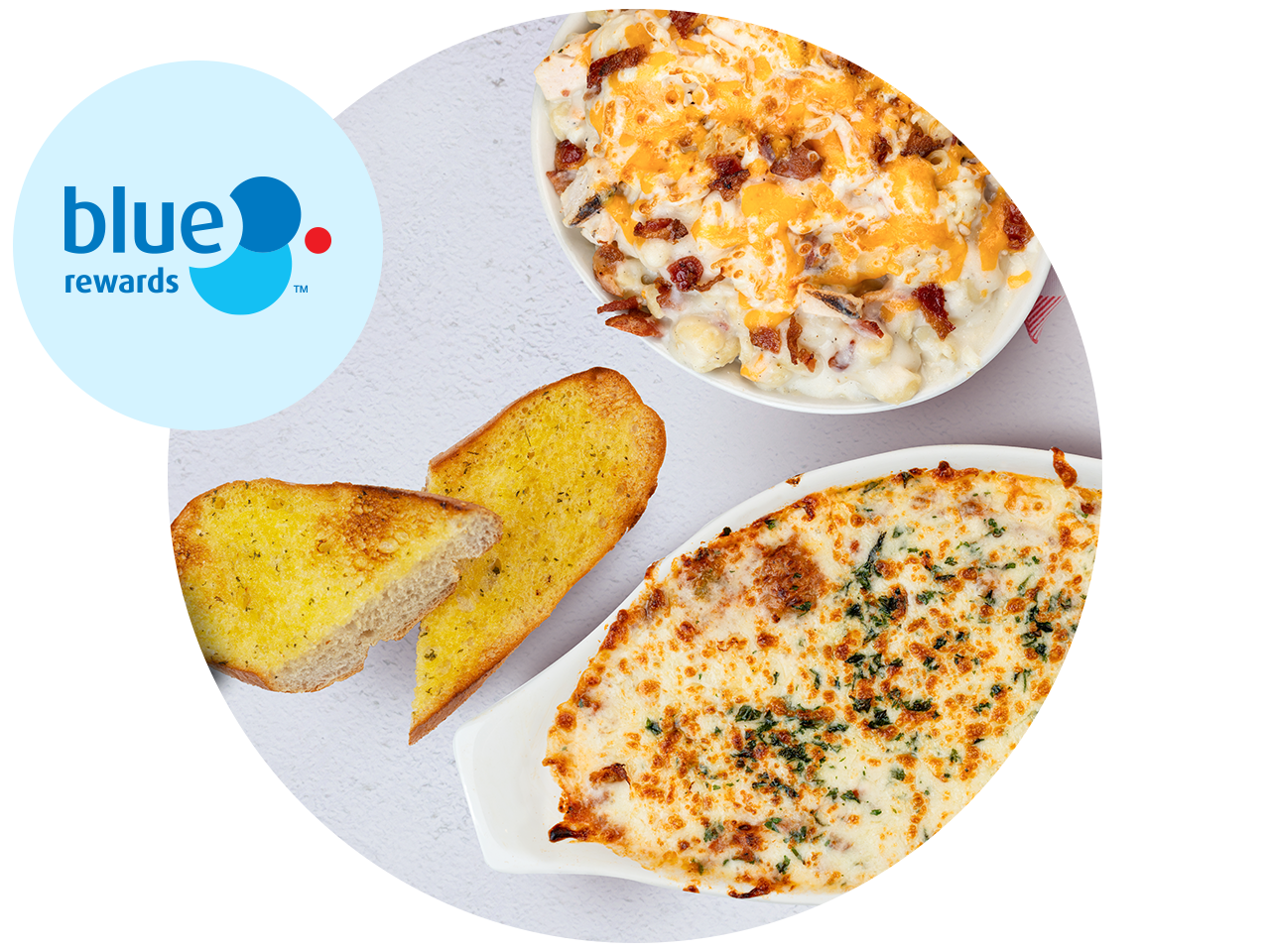 Blue Rewards logo beside two baked pasta dishes topped with melted cheese, served with garlic toast. One dish is topped with bacon pieces, and the other has a browned cheese topping with herbs.