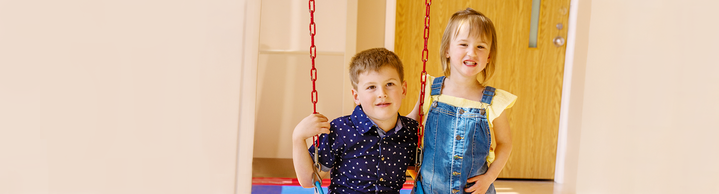A picture of a brother and a sister looking at the camera