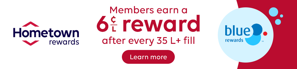Hometown Rewards promotional banner. Text: “Members earn a 6¢/L reward after every 35 L+ fill.” Hometown Rewards logo on the left, Blue Rewards logo on the right, and a “Learn more” button below the offer.