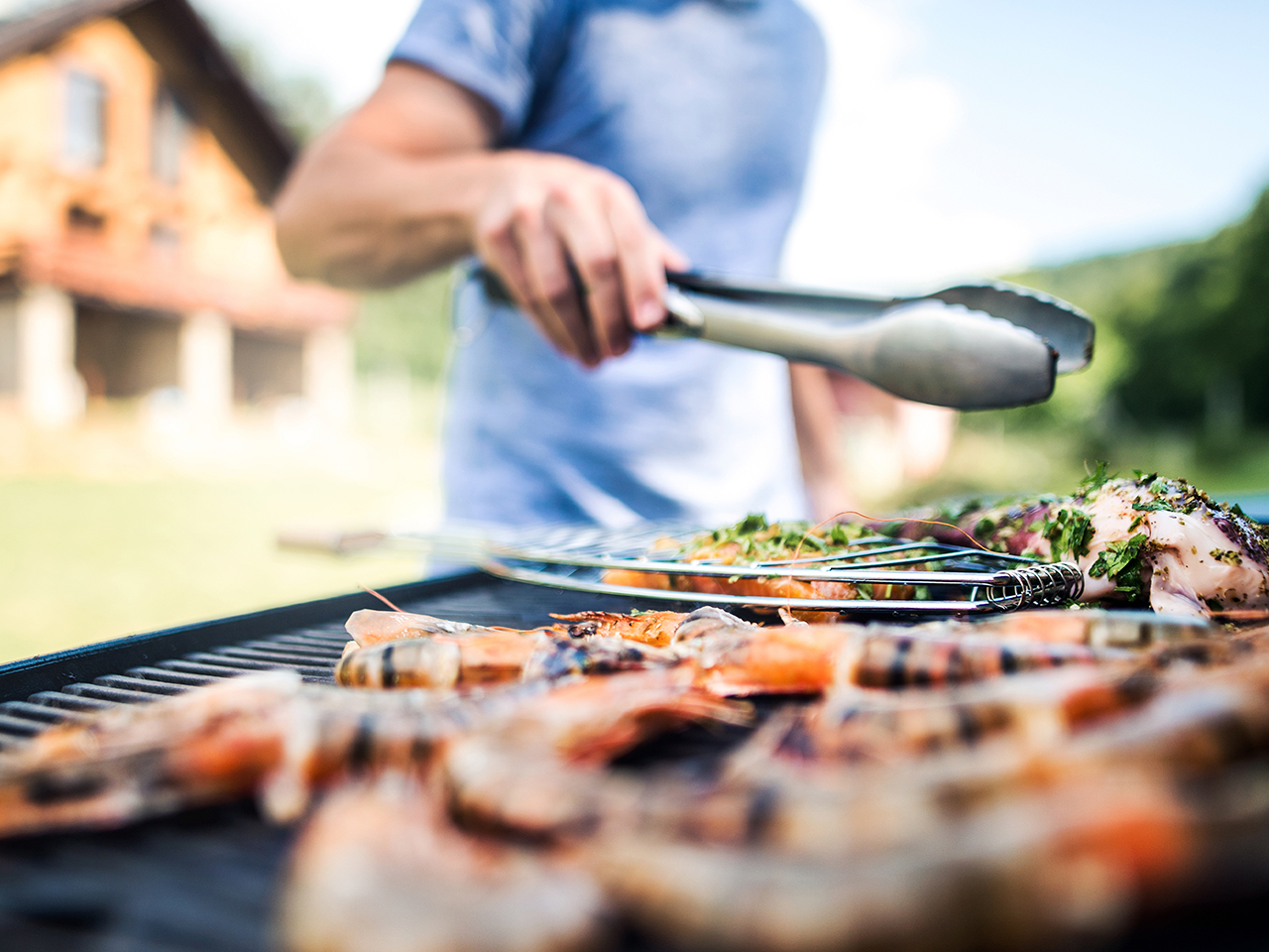 A man Grilling Chicken on propane burner