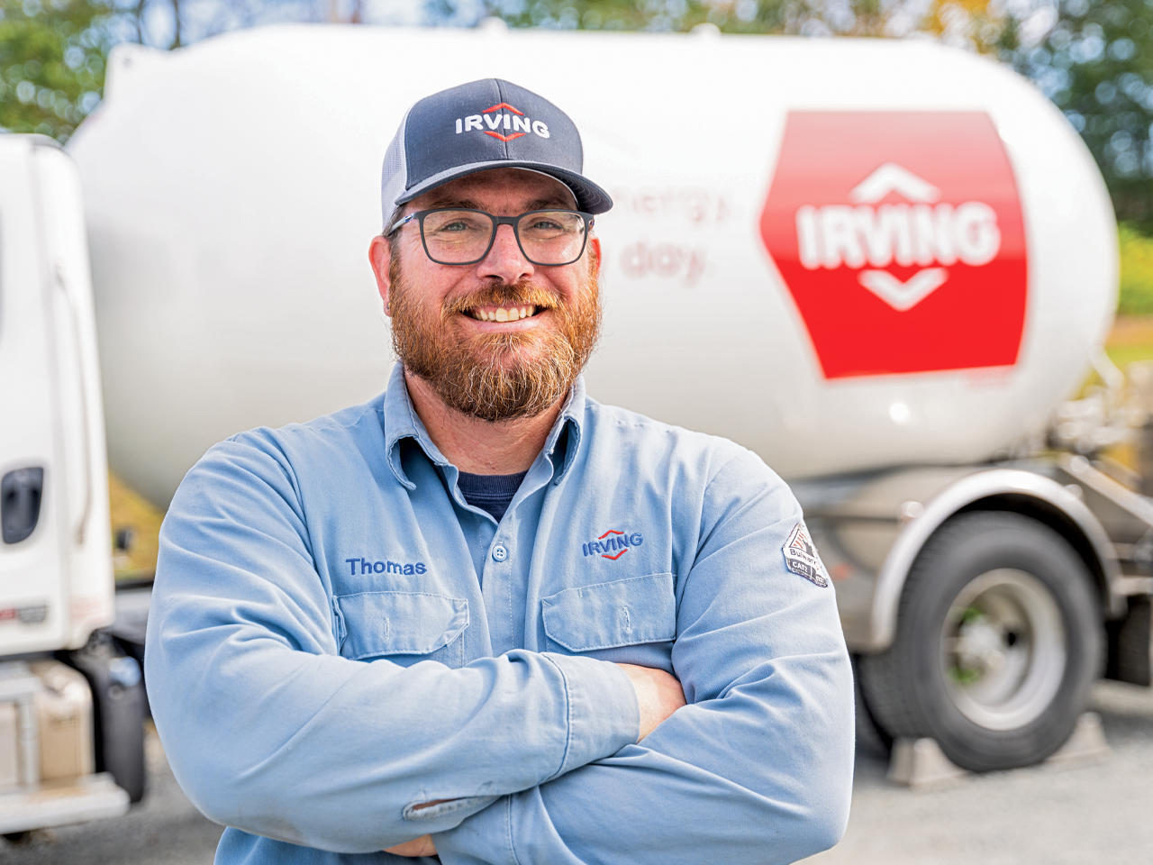Irving employee standing in front of an Irving fuel delivery truck.